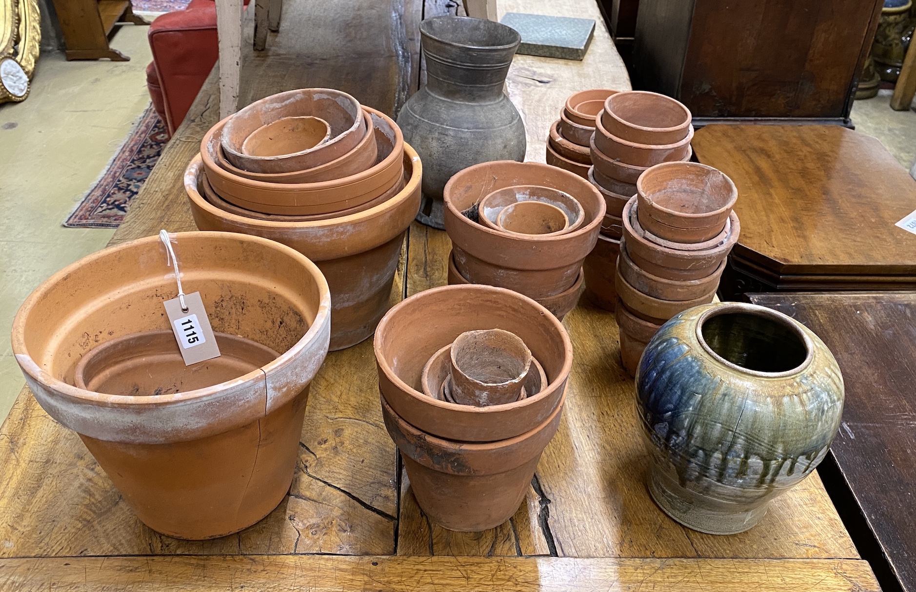 Approximately 40 assorted small terracotta pots, largest diameter 26cm, height 21cm together with two pottery vases